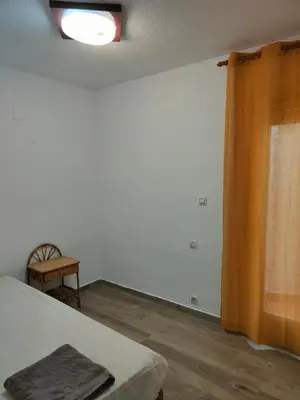 a room with a bed and a window and a chair at Avenida Mediterráneo in Puerto de Sagunto