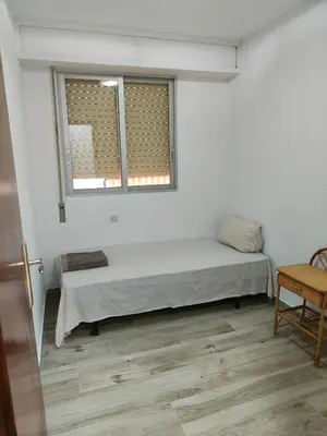 a room with a bed and two windows at Avenida Mediterráneo in Puerto de Sagunto