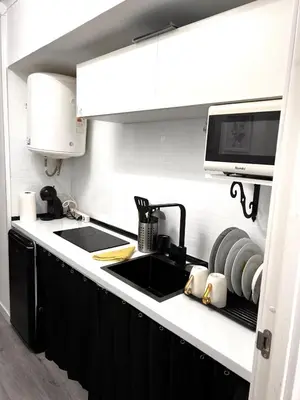 a kitchen with a sink and a microwave at Loft con balcón cercano al centro de Valencia in Valencia