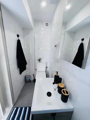 a white bathroom with a sink and a mirror at Loft con balcón cercano al centro de Valencia in Valencia