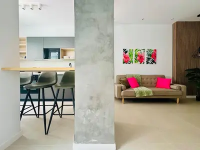 a living room with a couch and a table with pink pillows at PLANAS 3 Designer Aparment with Terraza in Ruzafa SOHO in Valencia