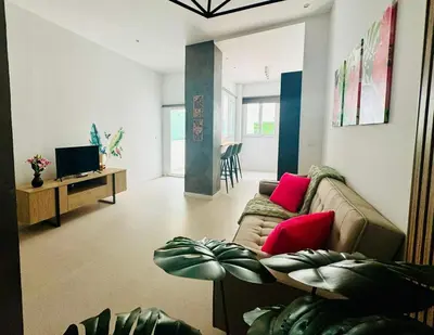 a living room with a couch and a tv at PLANAS 3 Designer Aparment with Terraza in Ruzafa SOHO in Valencia