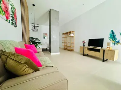 a living room with a couch and a television at PLANAS 3 Designer Aparment with Terraza in Ruzafa SOHO in Valencia