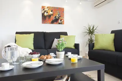 a living room with a table and a couch at Apartments Serrería II in Valencia