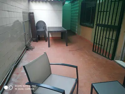 an empty room with two chairs and a table at EL Cid II in Valencia