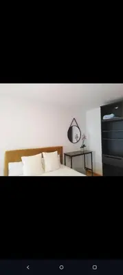 a bedroom with a bed and a table with a mirror at luxury and relax in Valencia