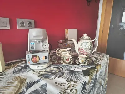 a coffee machine and cups on a table at luxury and relax in Valencia
