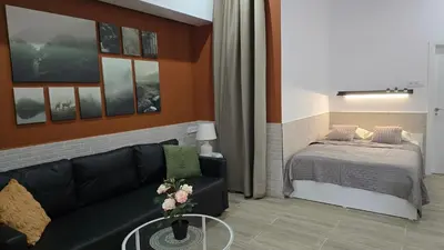 a living room with a couch and a bed at Apartamentos Vicent Clavel in Valencia