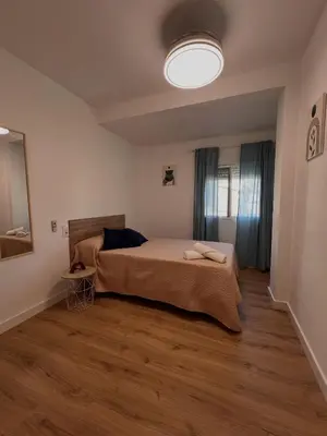 a bedroom with a bed and a light on the ceiling at El Surtidor in Anna