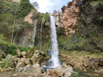 a waterfall on the side of a mountain at El Surtidor in Anna