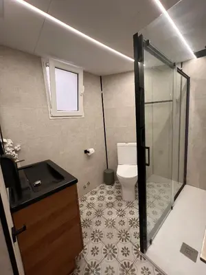 a bathroom with a toilet and a glass shower stall at El Surtidor in Anna