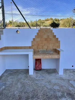 a baseball dugout with a bench and stairs at Casa el Catorce 18 in Bolbaite