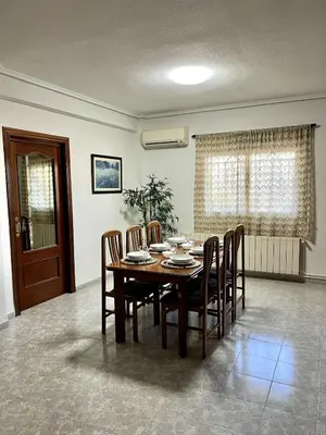 a dining room with a table and chairs at Casa el Catorce 18 in Bolbaite
