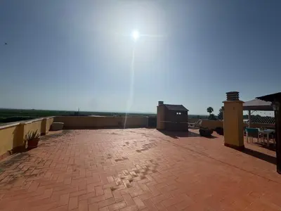 a view of a patio with the sun in the sky at Gaviota Azul, Perelló in Sueca