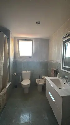 a bathroom with a toilet and a sink and a tub at Gaviota Azul, Perelló in Sueca