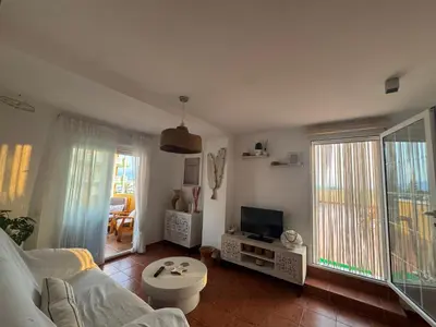 a living room with a couch and a tv at Gaviota Azul, Perelló in Sueca