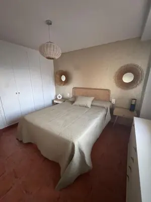 a bedroom with a large bed in a room at Gaviota Azul, Perelló in Sueca