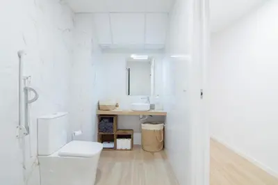 a white bathroom with a toilet and a sink at Casa Sant Domènec Savio in Valencia