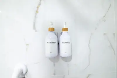 a group of three white bottles on a wall at Casa Sant Domènec Savio in Valencia