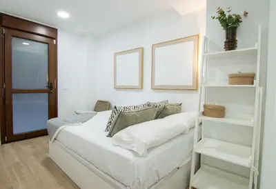 a bedroom with a bed with white shelves at Casa Sant Domènec Savio in Valencia