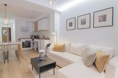 a living room with a white couch and a table at Casa Sant Domènec Savio in Valencia