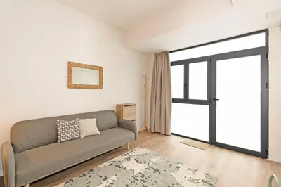 a living room with a couch and a window at GuestReady - Charming place in Valencia in Valencia