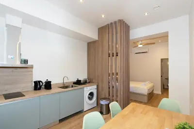 a kitchen with a sink and a table with a washing machine at GuestReady - Charming place in Valencia in Valencia