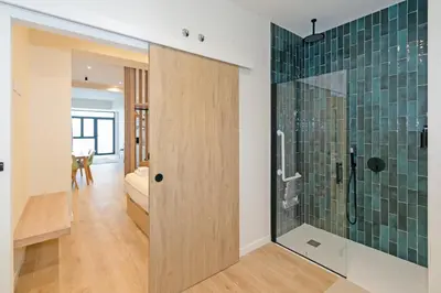 a bathroom with a shower with green tiles on the wall at GuestReady - Charming place in Valencia in Valencia