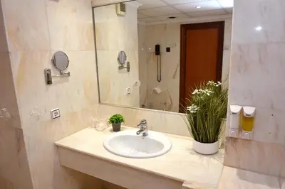 a bathroom with a sink and a mirror at Hotel Turia Valencia in Valencia