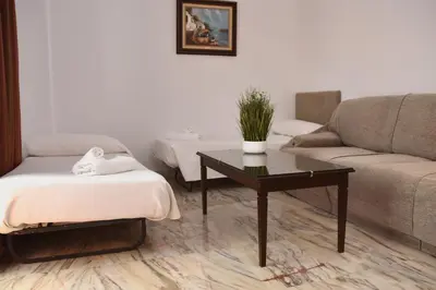 a living room with a couch and a coffee table at Hotel Turia Valencia in Valencia