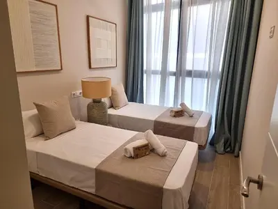 two beds in a room with a window at MD Senda del Aire in Valencia