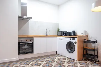 a kitchen with a washing machine and a sink at Quart Historic Stay 1 in Valencia