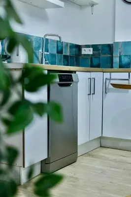 a kitchen with a sink and a counter top at Cozy Seaside Apartment in Cullera in Cullera