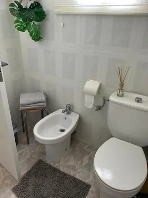 a bathroom with a white toilet and a sink at Apartamento Bahía Cullera II in Cullera