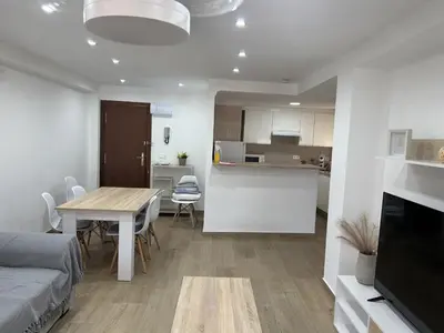 a living room and kitchen with a table and a couch at Apartamento Bahía Cullera II in Cullera
