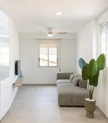 a living room with a couch and a plant at Aromes d'Espadà in Eslida
