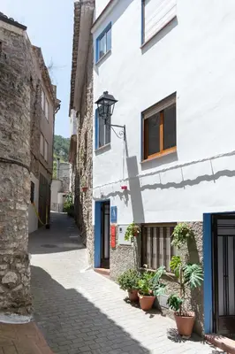 an alley in a town with a white building at Aromes d'Espadà in Eslida