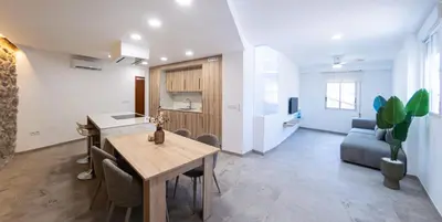 a kitchen and living room with a table and a couch at Aromes d'Espadà in Eslida