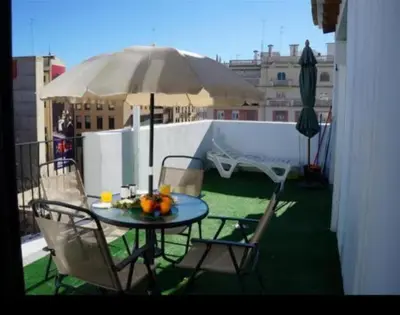 a patio with a wooden pergola and a table and chairs at Apartamento en Torres Quart -Centro in Valencia
