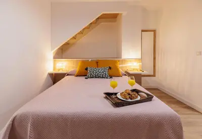 a bedroom with a bed with a tray of food on it at Urban apartment BAJO 6 - HOUSEVANLIVE in Valencia