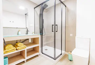 a bathroom with a shower and a toilet at Urban apartment BAJO 8 - HOUSEVANLIVE in Valencia