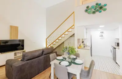 a living room with a couch and a table at Urban apartment BAJO 8 - HOUSEVANLIVE in Valencia