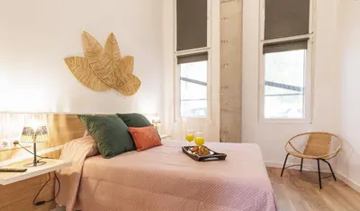 a room with a bed with two glasses on it at Urban apartment BAJO 8 - HOUSEVANLIVE in Valencia