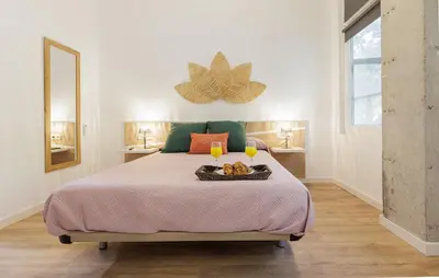 a bedroom with a bed with a tray of food on it at Urban apartment BAJO 8 - HOUSEVANLIVE in Valencia