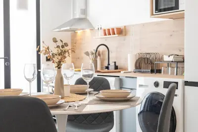 a kitchen with a table with wine glasses at Suite Deluxe Valencia - Beach Apartments I in Valencia