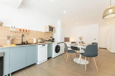 a kitchen and dining room with a table and chairs at Suite Deluxe Valencia - Beach Apartments I in Valencia