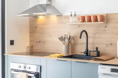 a kitchen with a sink and a stove at Suite Deluxe Valencia - Beach Apartments I in Valencia