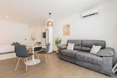 a living room with a couch and a table at Suite Deluxe Valencia - Beach Apartments I in Valencia