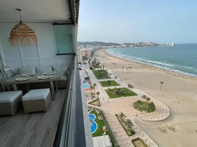 a balcony with a view of a beach and the ocean at Sobre el mar in Cullera