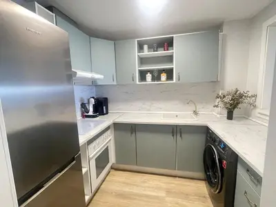 a kitchen with a refrigerator and a dishwasher at Sobre el mar in Cullera